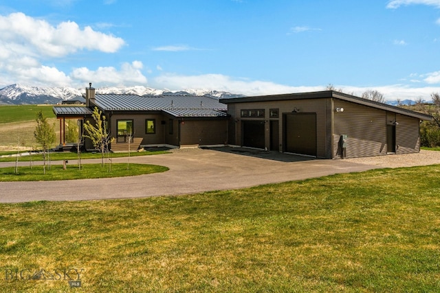 20 Prairie Falcon Ln, Belgrade, MT 59714 - view of front facade with a garage, a front yard, driveway, and a standing seam roof