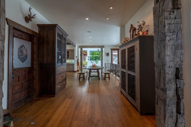 dining space featuring wood-type flooring and recessed lighting