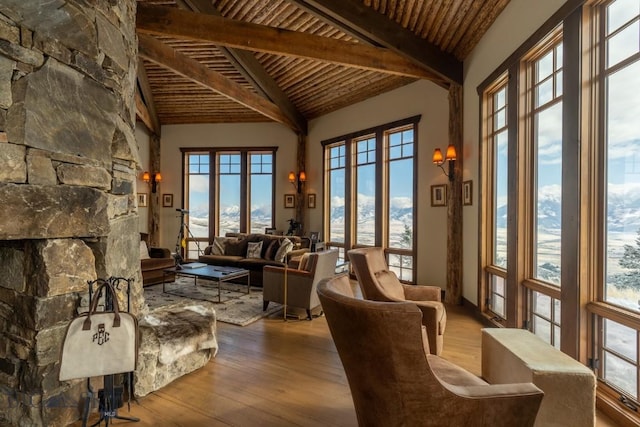 living area featuring beam ceiling, wood finished floors, wooden ceiling, and high vaulted ceiling
