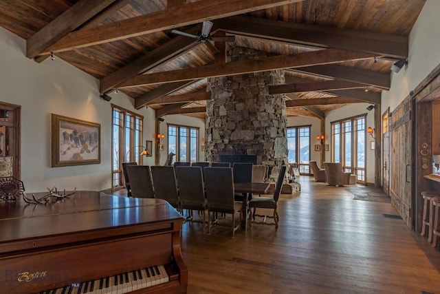 dining space featuring wood ceiling, ceiling fan, beam ceiling, healthy amount of natural light, and wood finished floors