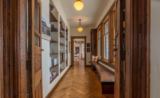 hall featuring baseboards