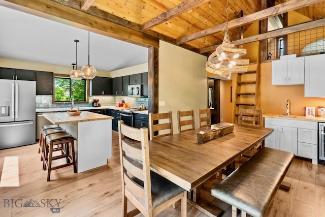 dining area with beam ceiling, light wood-style floors, wooden ceiling, a chandelier, and beverage cooler