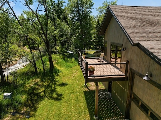 view of grassy yard featuring a wooden deck