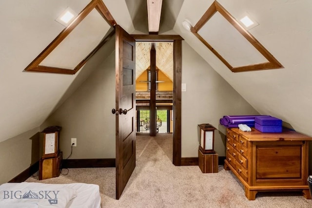 bonus room with a skylight, vaulted ceiling, light colored carpet, and baseboards