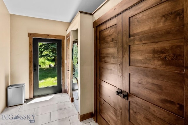 doorway featuring light tile patterned flooring