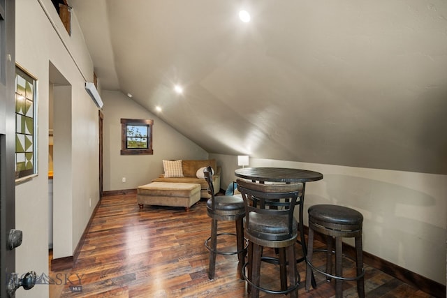 sitting room featuring dark wood-style floors, lofted ceiling, and baseboards