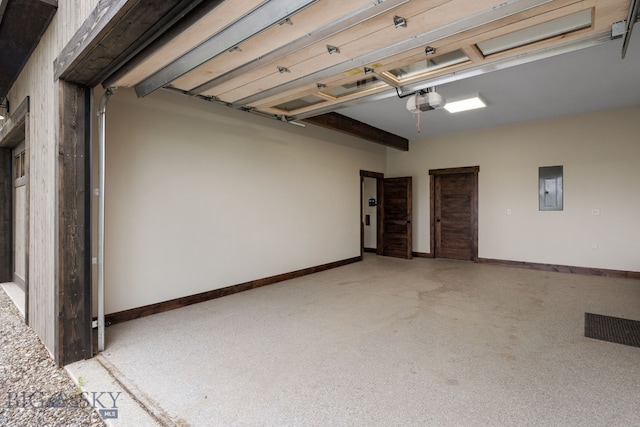 garage with electric panel, a garage door opener, and baseboards