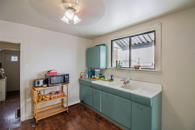 1048 S Wyoming St, Butte, MT 59701 - kitchen featuring stainless steel microwave, green cabinets, a ceiling fan, and dark wood-style floors