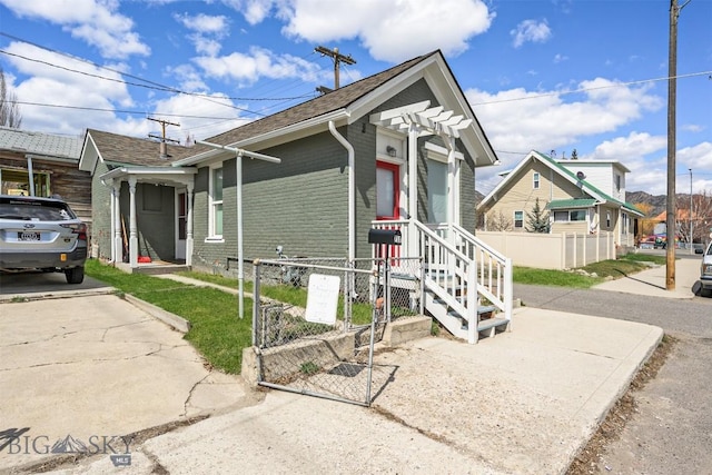 1048 S Wyoming St, Butte, MT 59701 - ranch-style home featuring brick siding, a shingled roof, and a gate