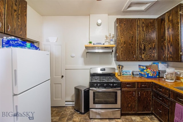 1048 S Wyoming St, Butte, MT 59701 - kitchen with freestanding refrigerator, stainless steel range with gas cooktop, dark brown cabinets, under cabinet range hood, and stone finish flooring
