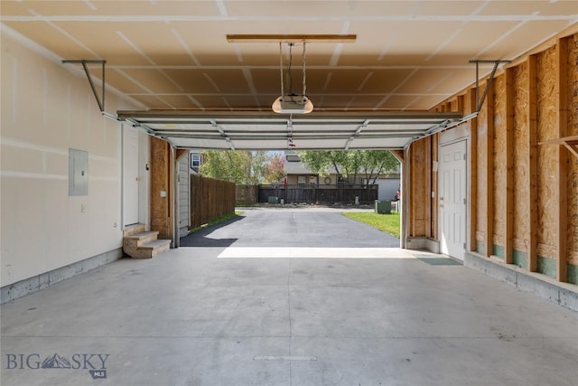 550 Green Tree, Belgrade, MT 59714 - garage with a garage door opener, electric panel, and fence