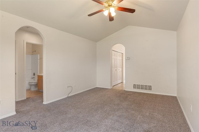 550 Green Tree, Belgrade, MT 59714 - carpeted empty room featuring ceiling fan, arched walkways, lofted ceiling, and baseboards