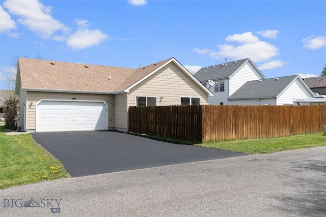 550 Green Tree, Belgrade, MT 59714 - view of front of house with fence, a garage, and asphalt driveway