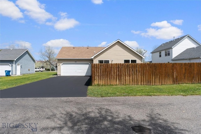 550 Green Tree, Belgrade, MT 59714 - view of front of home with asphalt driveway, a garage, and fence
