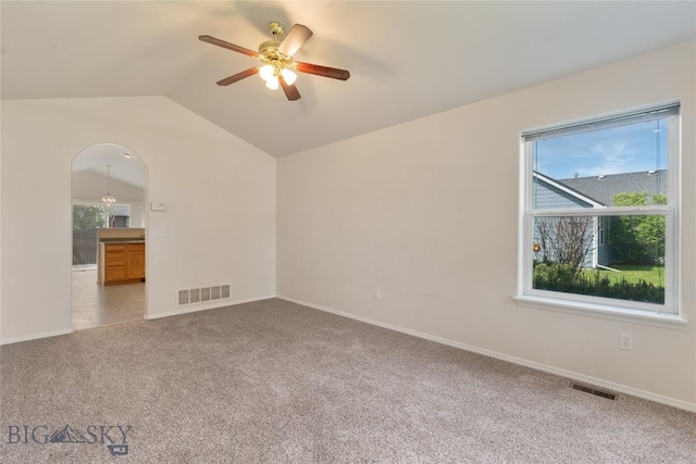 550 Green Tree, Belgrade, MT 59714 - carpeted spare room featuring a ceiling fan, lofted ceiling, baseboards, and arched walkways