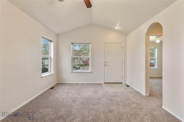550 Green Tree, Belgrade, MT 59714 - unfurnished room with a ceiling fan, light colored carpet, arched walkways, vaulted ceiling, and baseboards