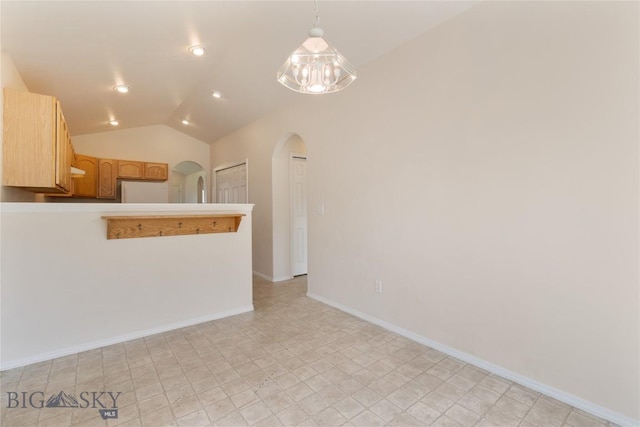 550 Green Tree, Belgrade, MT 59714 - spare room featuring arched walkways, vaulted ceiling, baseboards, and recessed lighting
