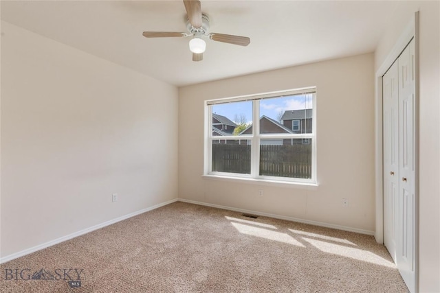 550 Green Tree, Belgrade, MT 59714 - unfurnished bedroom with carpet flooring, a closet, baseboards, and a ceiling fan