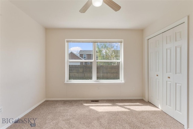 550 Green Tree, Belgrade, MT 59714 - unfurnished bedroom with carpet floors, a closet, baseboards, and a ceiling fan