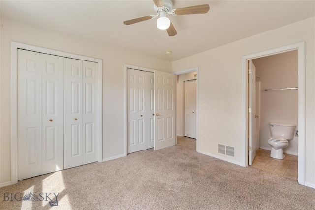 550 Green Tree, Belgrade, MT 59714 - unfurnished bedroom featuring two closets, carpet flooring, baseboards, and ensuite bath