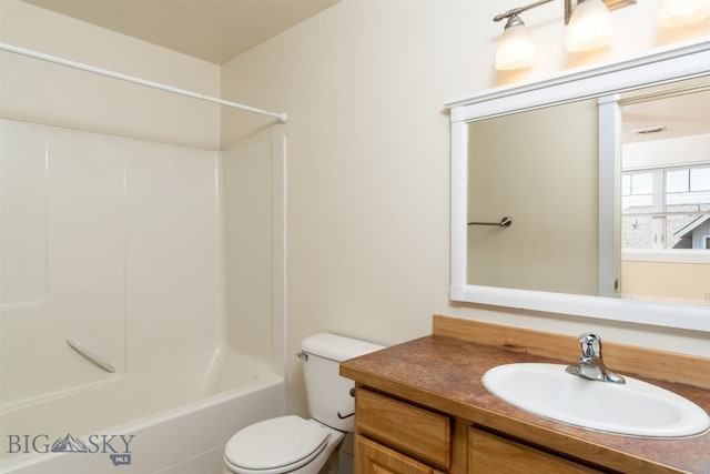 bathroom featuring vanity, toilet, and shower / bathtub combination