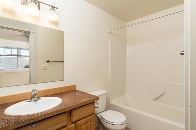 bathroom with toilet, vanity, and washtub / shower combination
