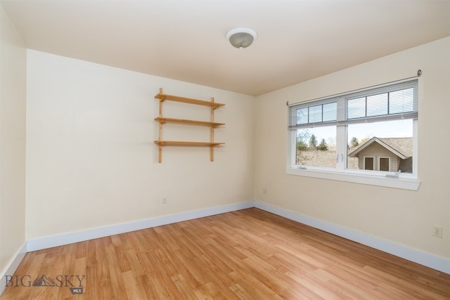 unfurnished room with light wood-style floors and baseboards