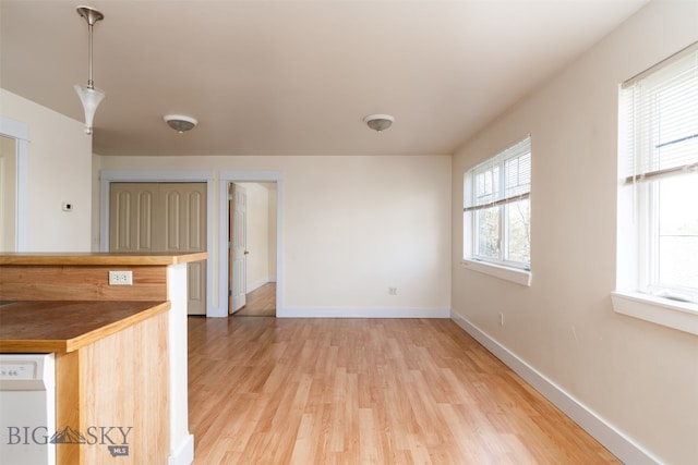 unfurnished room featuring light wood-style flooring and baseboards