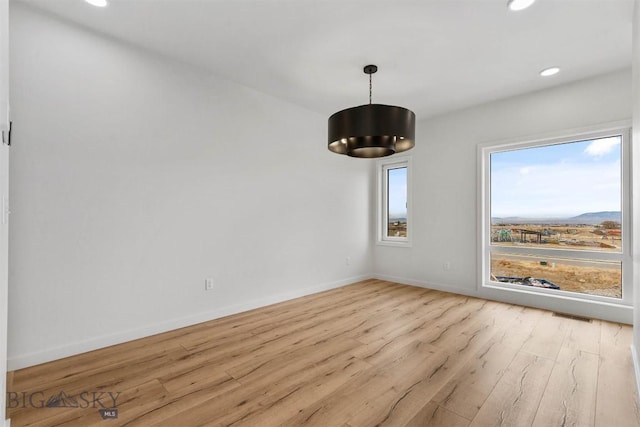 unfurnished dining area featuring wood finished floors, recessed lighting, and baseboards