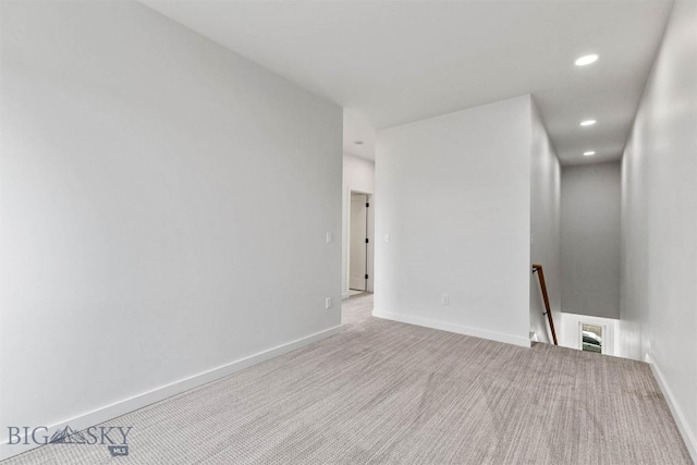 carpeted empty room featuring recessed lighting and baseboards