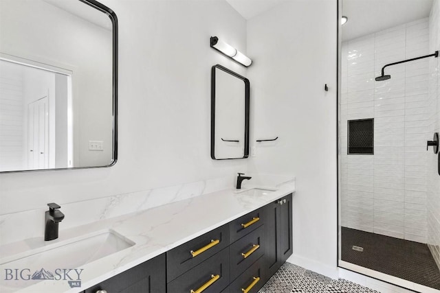 bathroom featuring a stall shower, double vanity, and tile patterned flooring