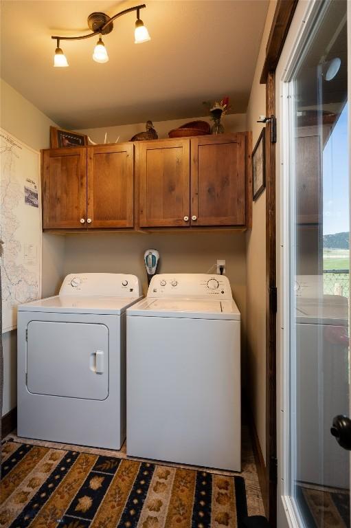 laundry area with cabinet space and separate washer and dryer