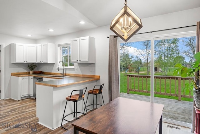 285 Hereford Dr, Belgrade, MT 59714 - kitchen featuring a sink, stainless steel dishwasher, recessed lighting, white cabinetry, and dark wood-type flooring