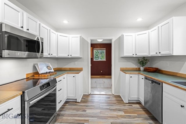 285 Hereford Dr, Belgrade, MT 59714 - kitchen featuring stainless steel appliances, light wood-type flooring, white cabinetry, recessed lighting, and baseboards