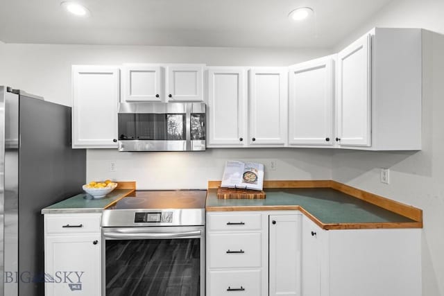 285 Hereford Dr, Belgrade, MT 59714 - kitchen featuring appliances with stainless steel finishes, dark countertops, white cabinetry, and recessed lighting