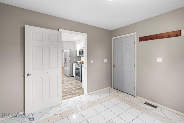 285 Hereford Dr, Belgrade, MT 59714 - spare room with light tile patterned floors and baseboards