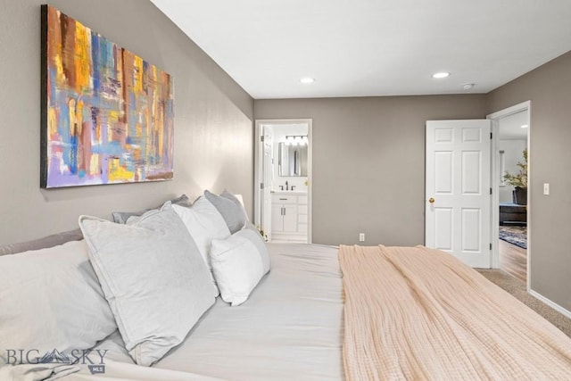285 Hereford Dr, Belgrade, MT 59714 - carpeted bedroom featuring baseboards, recessed lighting, ensuite bath, and a sink