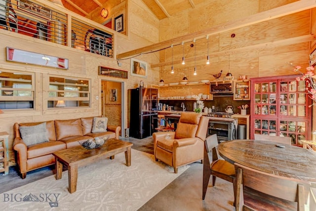 1007 E Geyser, Livingston, MT 59047 - living room featuring concrete floors, high vaulted ceiling, and beam ceiling