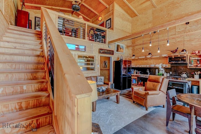 1007 E Geyser, Livingston, MT 59047 - living area featuring stairs, high vaulted ceiling, beamed ceiling, and concrete floors