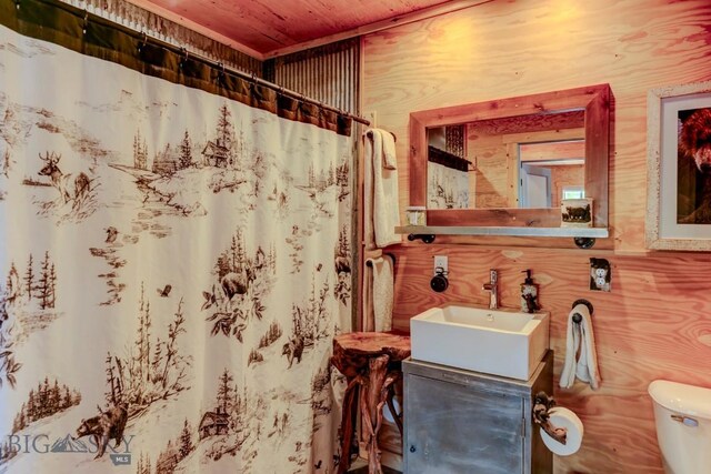 1007 E Geyser, Livingston, MT 59047 - bathroom featuring wooden ceiling, toilet, vanity, and a shower with curtain