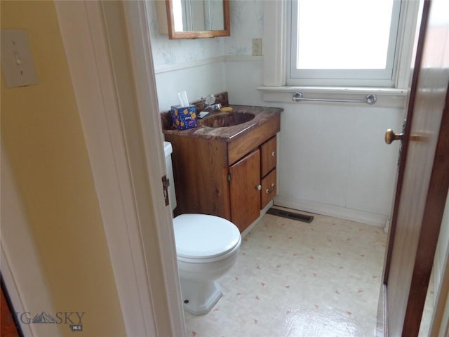 523 Hickory, Anaconda, MT 59711 - half bath featuring tile patterned floors, toilet, vanity, and wainscoting