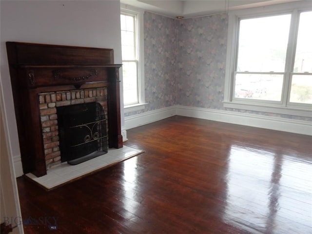 523 Hickory, Anaconda, MT 59711 - unfurnished living room featuring hardwood / wood-style flooring, plenty of natural light, baseboards, and a tiled fireplace
