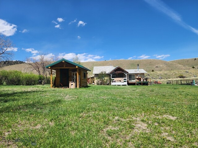 967 Mt Highway 2 W, Whitehall, MT 59759 - view of yard with a deck with mountain view and an outdoor structure