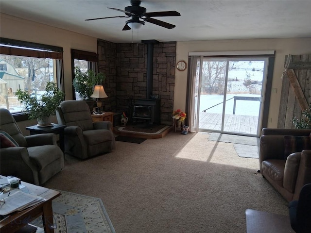 967 Mt Highway 2 W, Whitehall, MT 59759 - carpeted living area with a wood stove and ceiling fan