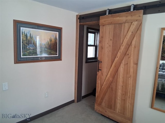967 Mt Highway 2 W, Whitehall, MT 59759 - empty room featuring a barn door, carpet floors, and baseboards