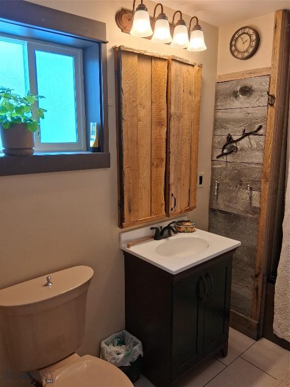 967 Mt Highway 2 W, Whitehall, MT 59759 - bathroom featuring vanity, tile patterned flooring, and toilet