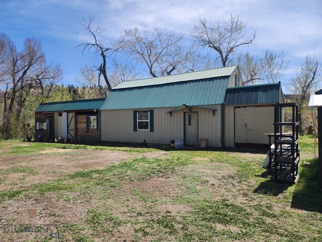 967 Mt Highway 2 W, Whitehall, MT 59759 - rear view of house featuring metal roof, a gambrel roof, and a lawn