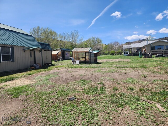 967 Mt Highway 2 W, Whitehall, MT 59759 - view of yard featuring an outbuilding and a greenhouse