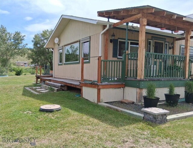 967 Mt Highway 2 W, Whitehall, MT 59759 - view of side of property with covered porch and a yard