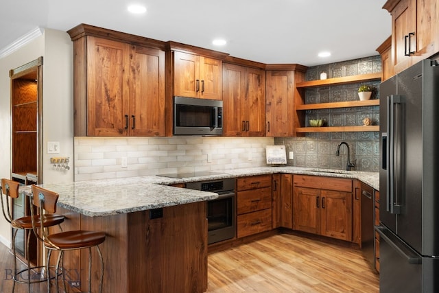 kitchen with stainless steel appliances, a sink, open shelves, a peninsula, and ornamental molding